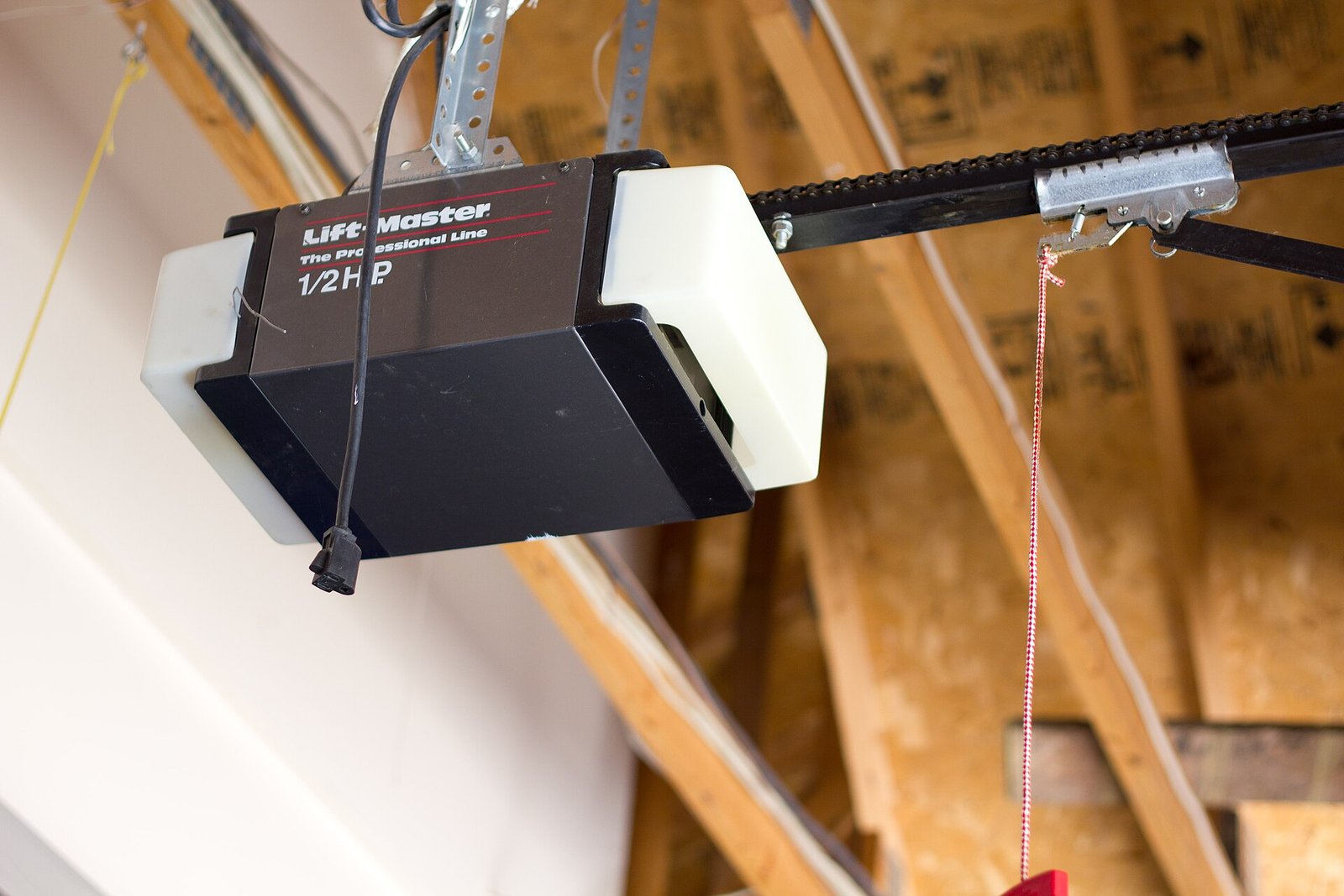 Garage door opener motor mounted to a garage ceiling