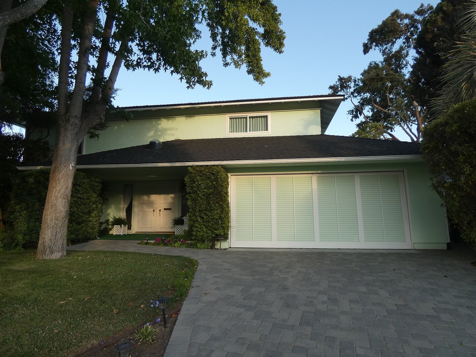 House with a white two-car garage door and a driveway