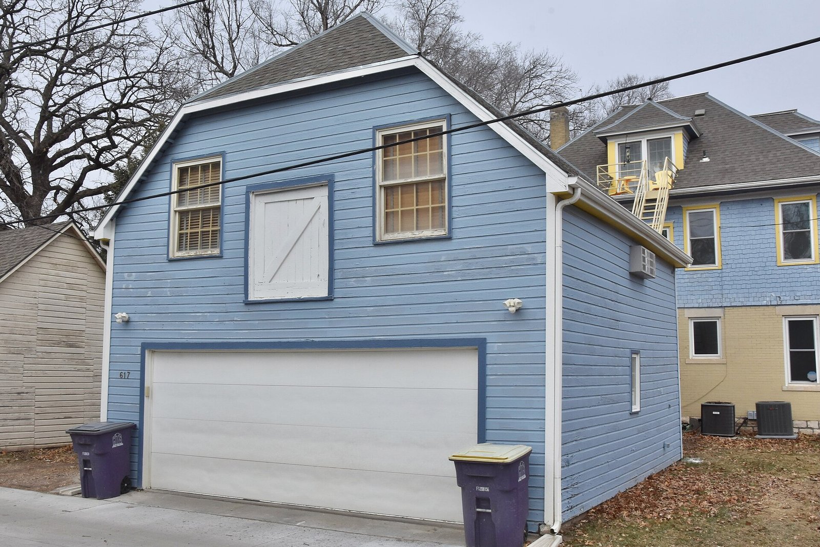 Residential detached garage with a two-car garage door and driveway